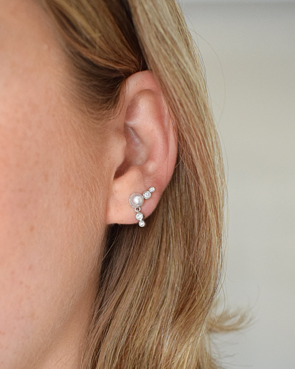 Diamond and Pearl earring in the ear