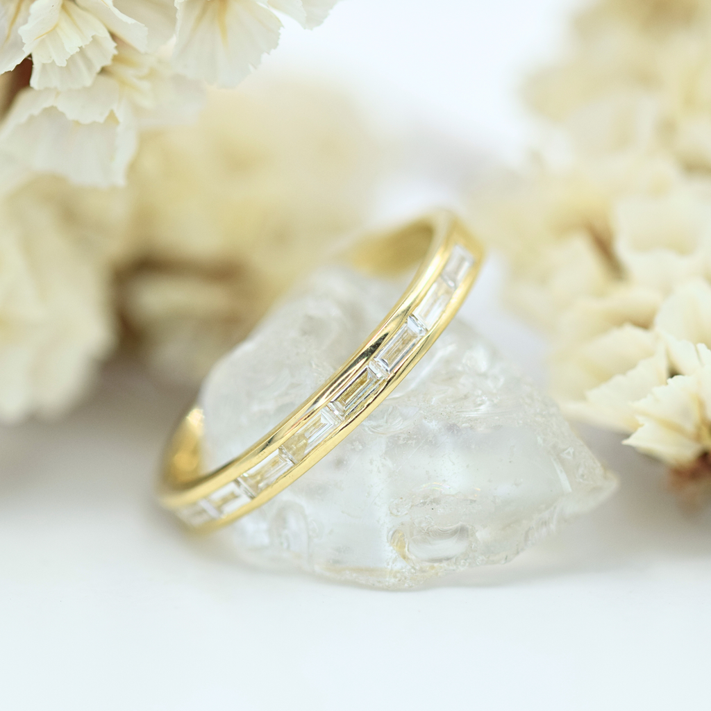 baguette cut white diamond channel set yellow gold wedding band 