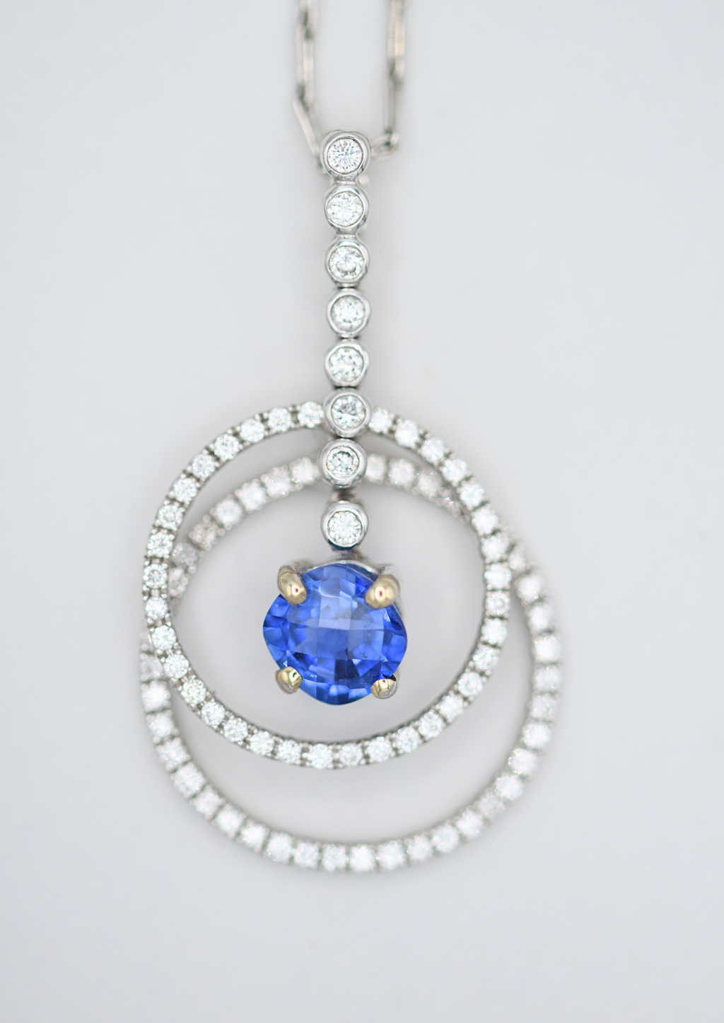 cushion cut royal blue sapphire and double halo of diamonds necklace