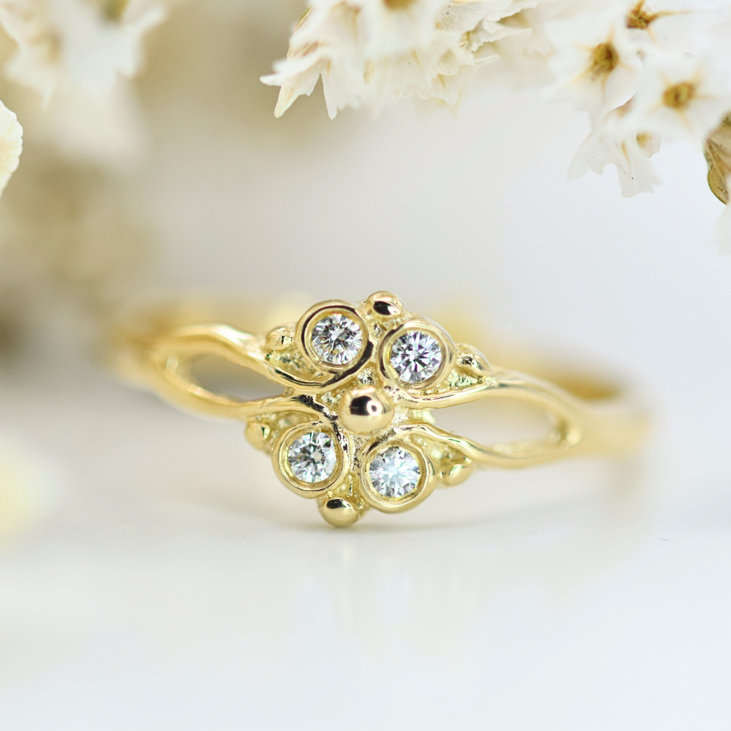 decorative yellow gold ring with four rbc diamonds