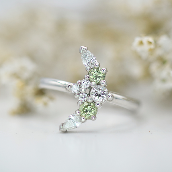 green and white diamond crescent platinum ring
