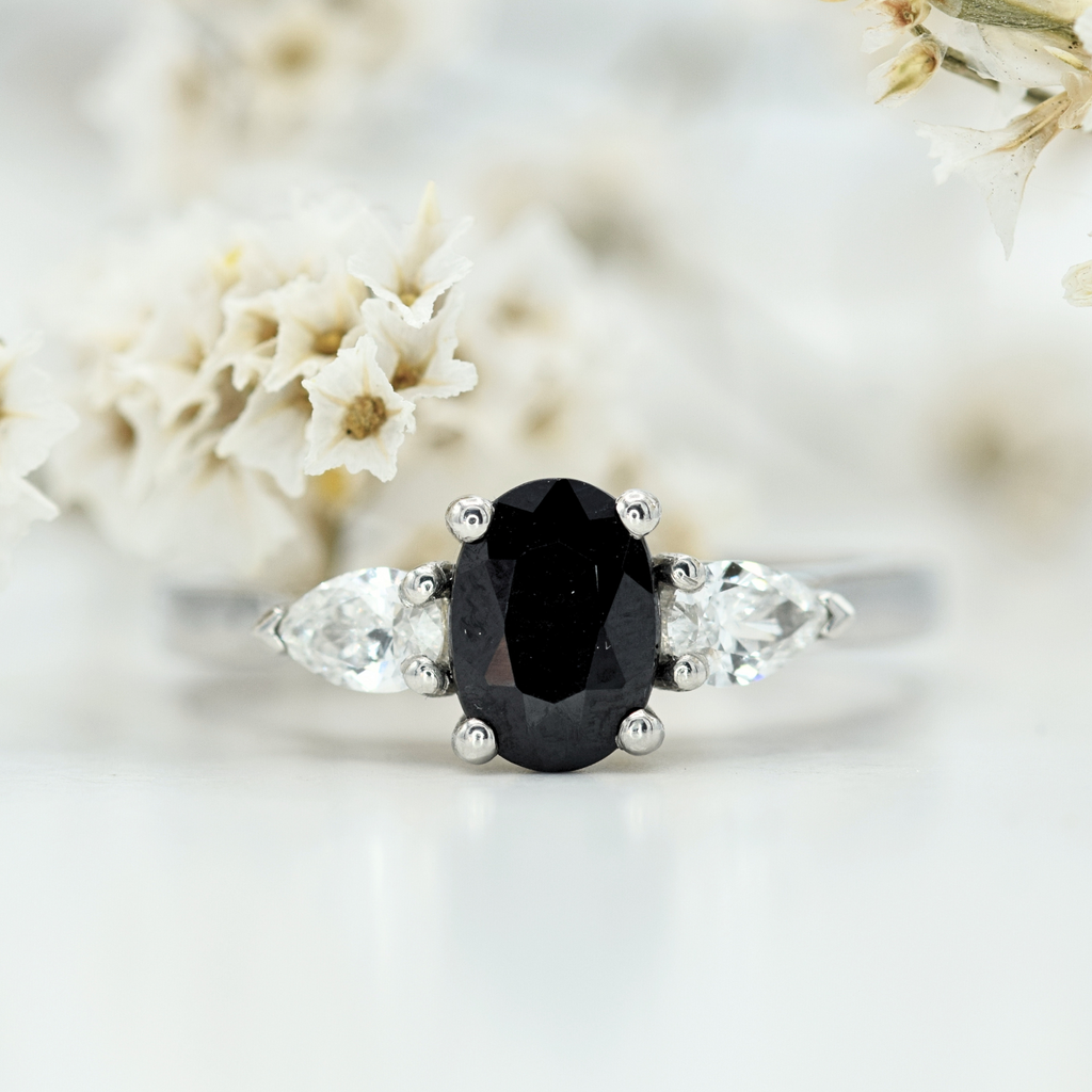 oval black sapphire and pear white diamond three stone in platinum