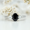 oval black sapphire and pear white diamond three stone in platinum