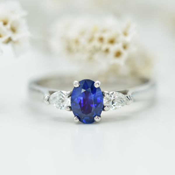 oval blue sapphire and pear white diamond three stone ring in platinum