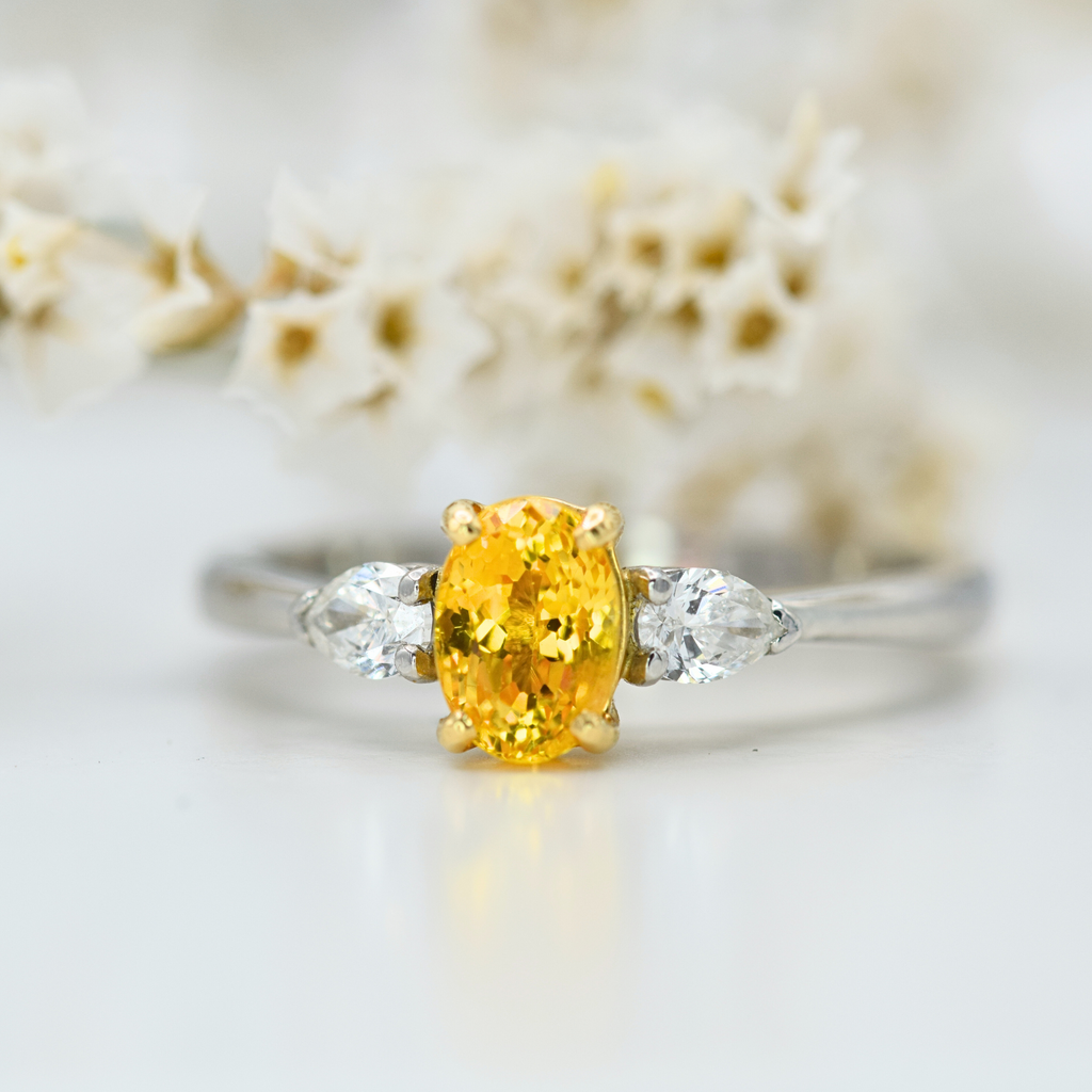 oval orange sapphire and white pear diamond three stone ring in platinum
