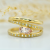 peach pear cut morganite set horizontally on wrap around diamond set gold ring