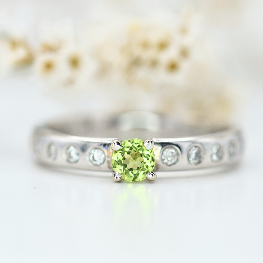 peridot ring and flush set diamond white gold band