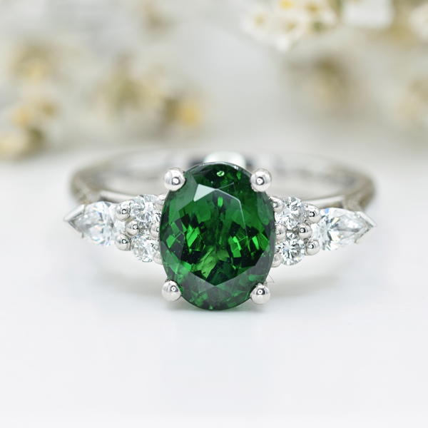 platinum oval tsavourite ring with diamond shoulders