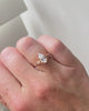 lab-grown pear diamond with marquise and round natural diamond side stones in 18k rose gold on hand