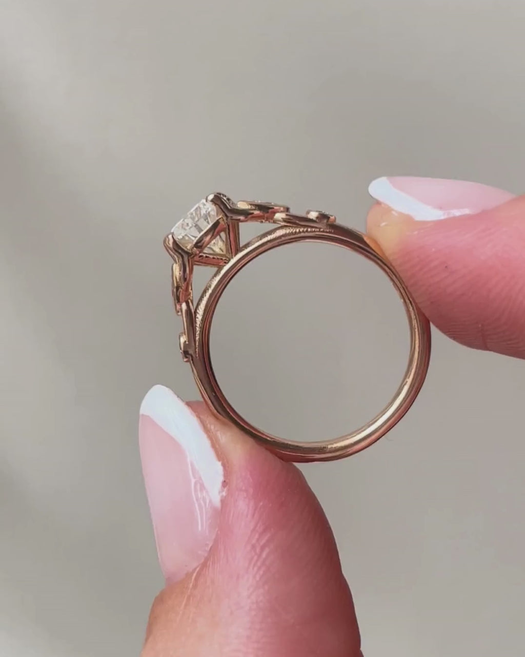 lab-grown pear diamond with marquise and round natural diamond side stones in 18k rose gold side shot