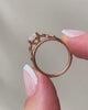 lab-grown pear diamond with marquise and round natural diamond side stones in 18k rose gold side shot