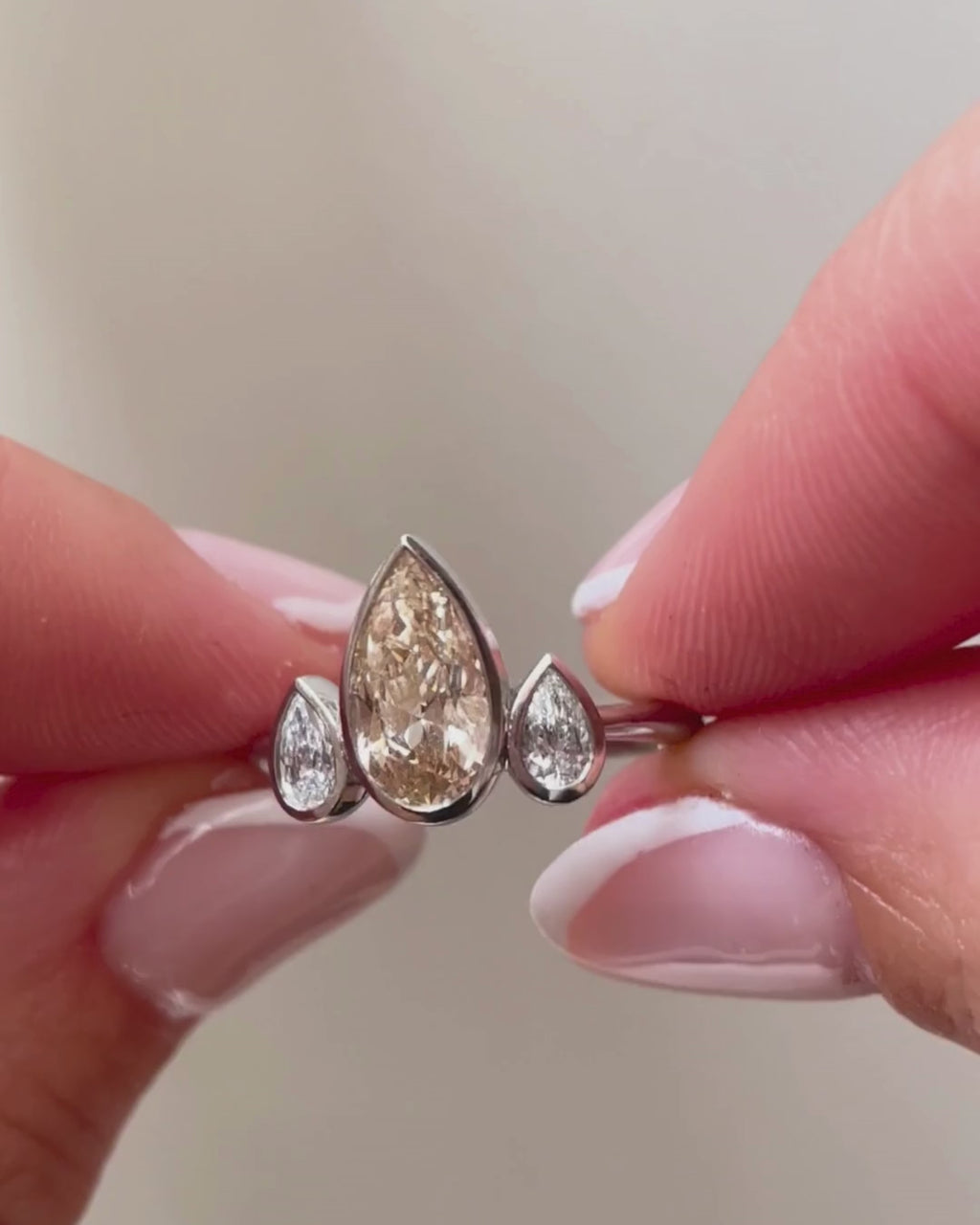 champagne and white diamond three stone ring - in hands