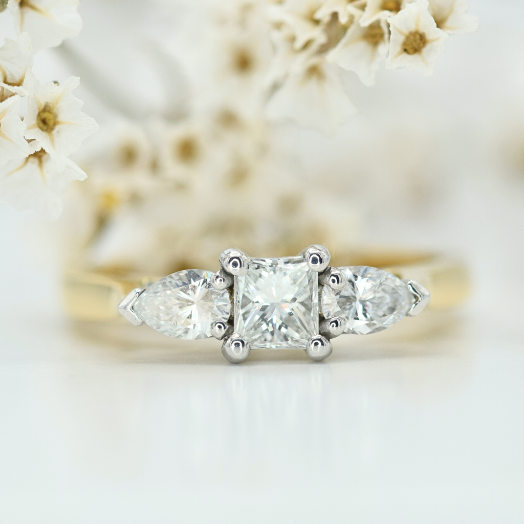 princess cut and pear diamond three stone ring in yellow gold