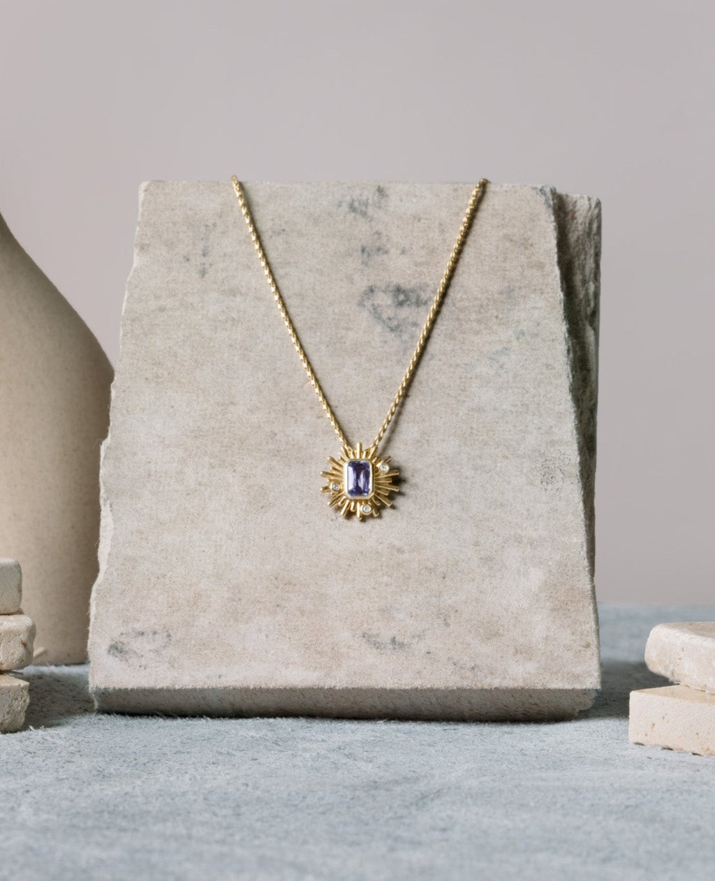 purple sapphire starburst pendant in yellow gold