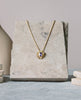 purple sapphire starburst pendant in yellow gold
