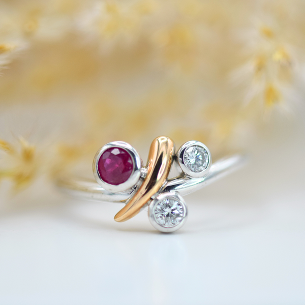 white and rose gold ruby and white diamond swirl ring