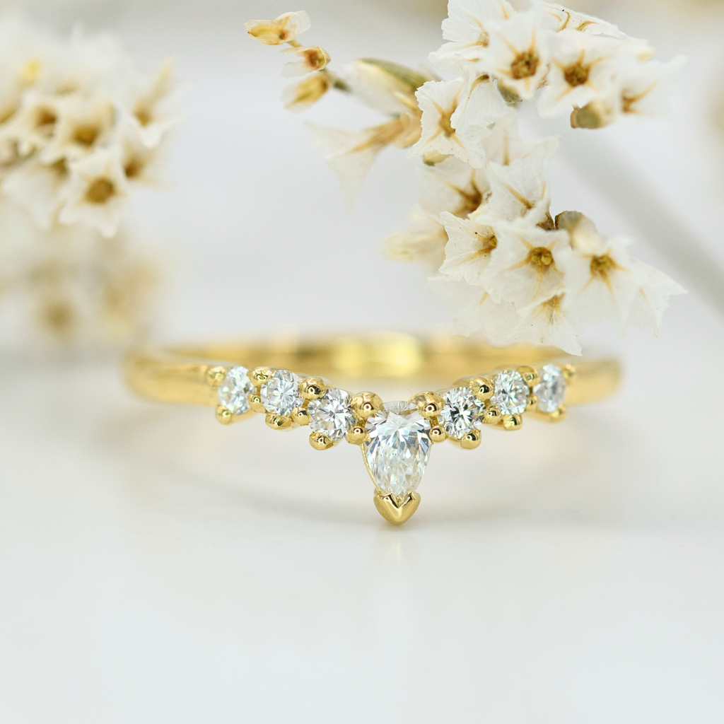 white round and pear diamond soft curve wedding band in yellow gold
